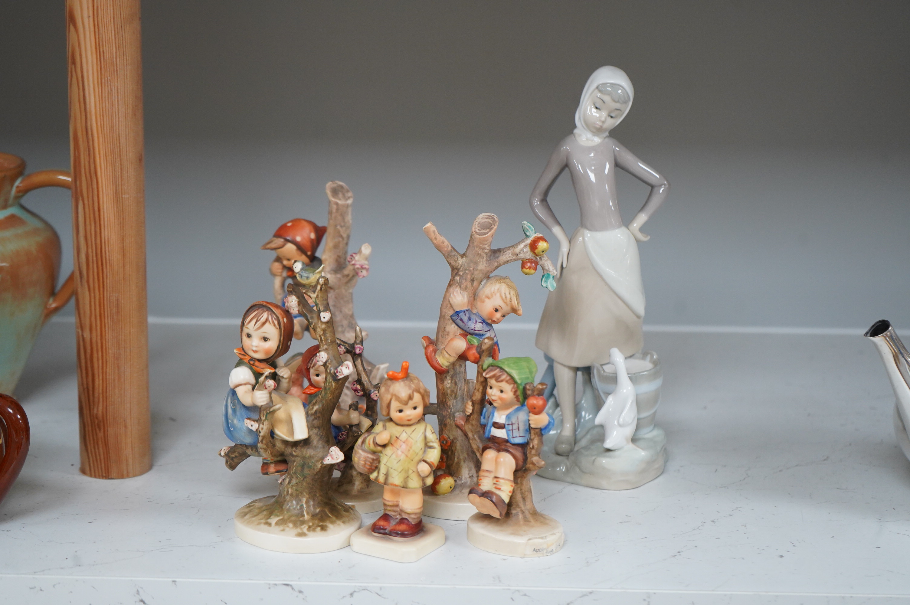 Six various Goebel figures and a Lladro figure, 24cm high